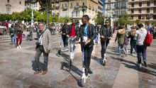 Un grupo de jóvenes en patinete por la plaza de la Virgen.