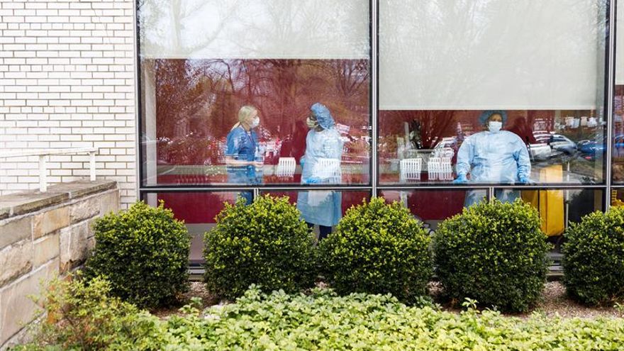 Healthcare workers stand a window at Jacobi Medical Center as nurses rally to protest their lack of personal protective equipment, PPE, and institutional support in the Bronx, New York, USA, on 17 April 2020.