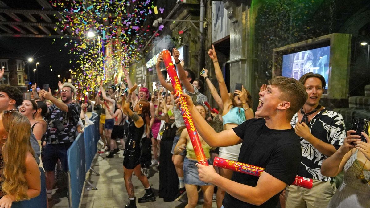 People celebrate as they queue up to enter the Viaduct Bar in Leeds after the final legal coronavirus restrictions were lifted in England at midnight.