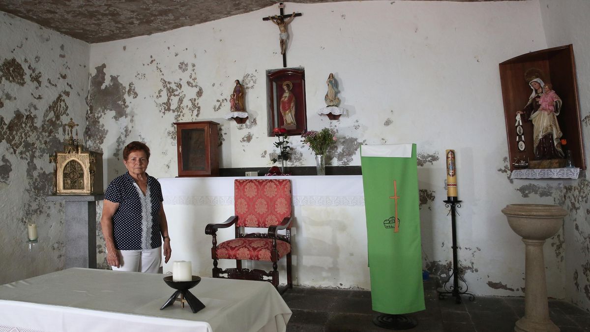 Una vecina, en el interior de la ermita antes de su restauración, con desperfectos en paredes y techo.