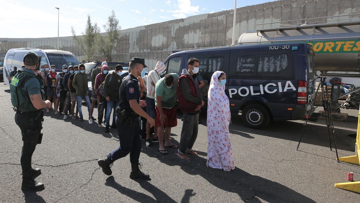 20 hombres y una mujer llegados en patera a Pozo Izquierdo esperan en fila para entrar al muelle de Arguineguín