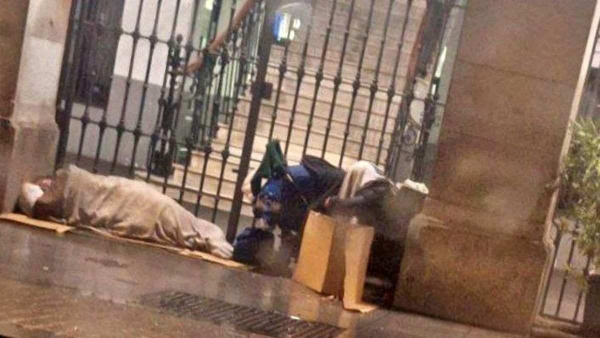A family member sleeps on the porch of Madrid's Samour Social