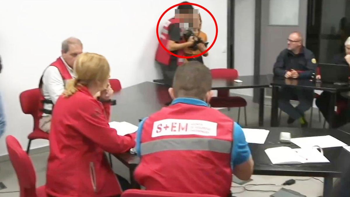 The camera operator talks with the press head at the Emergency Coordination Center.