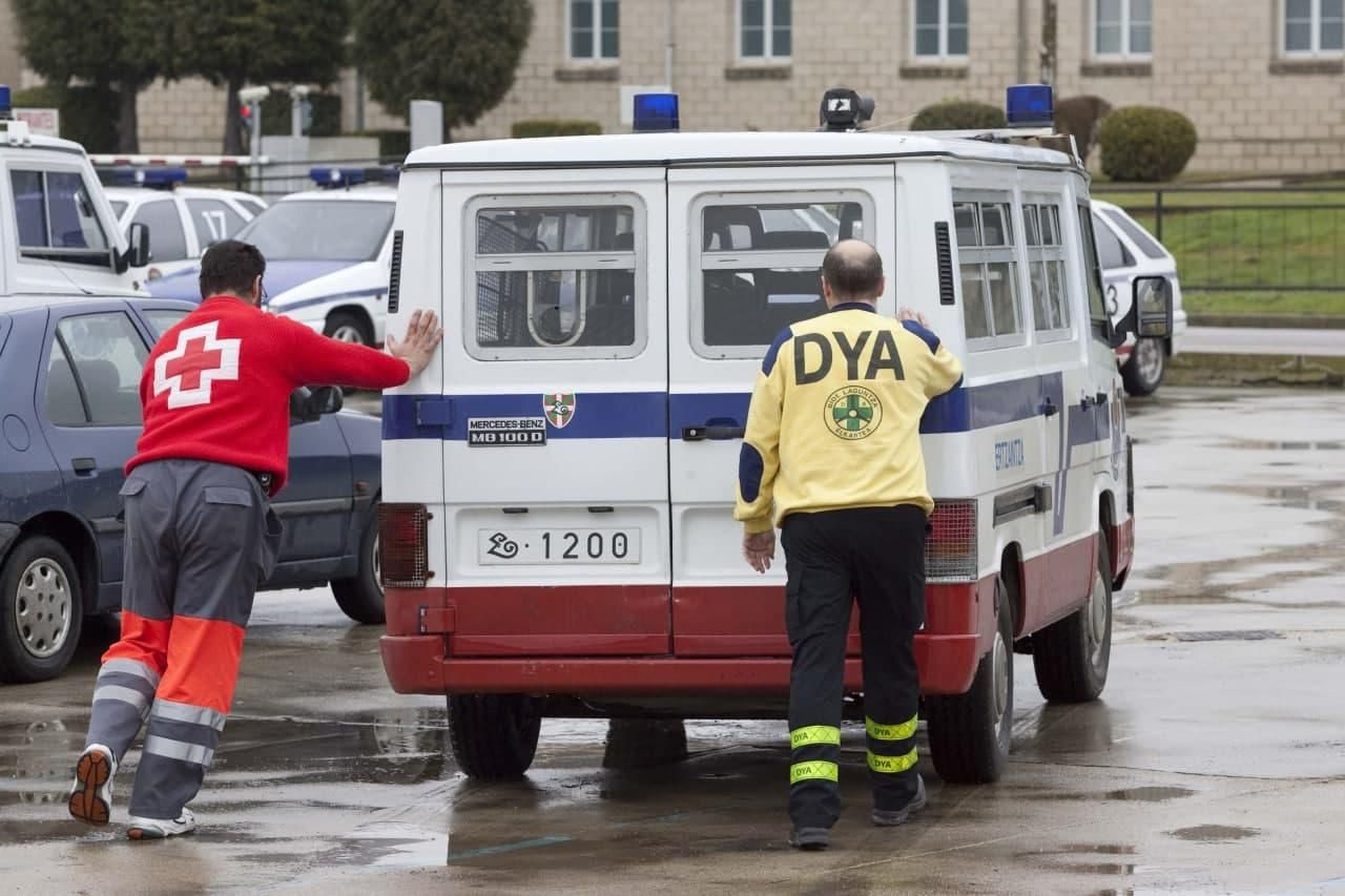 Dos sanitarios empujan una furgoneta averiada
