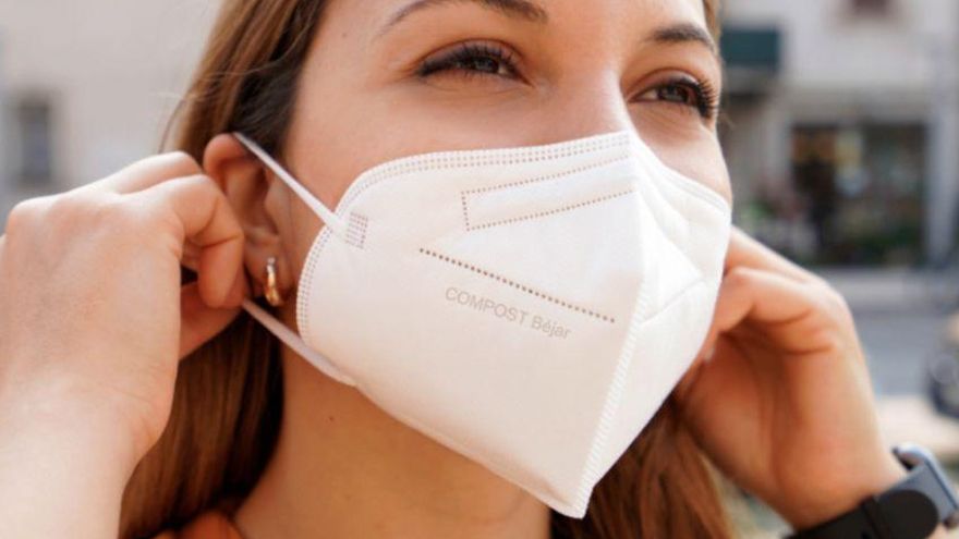 Una mujer utilizando una mascarilla compostable.