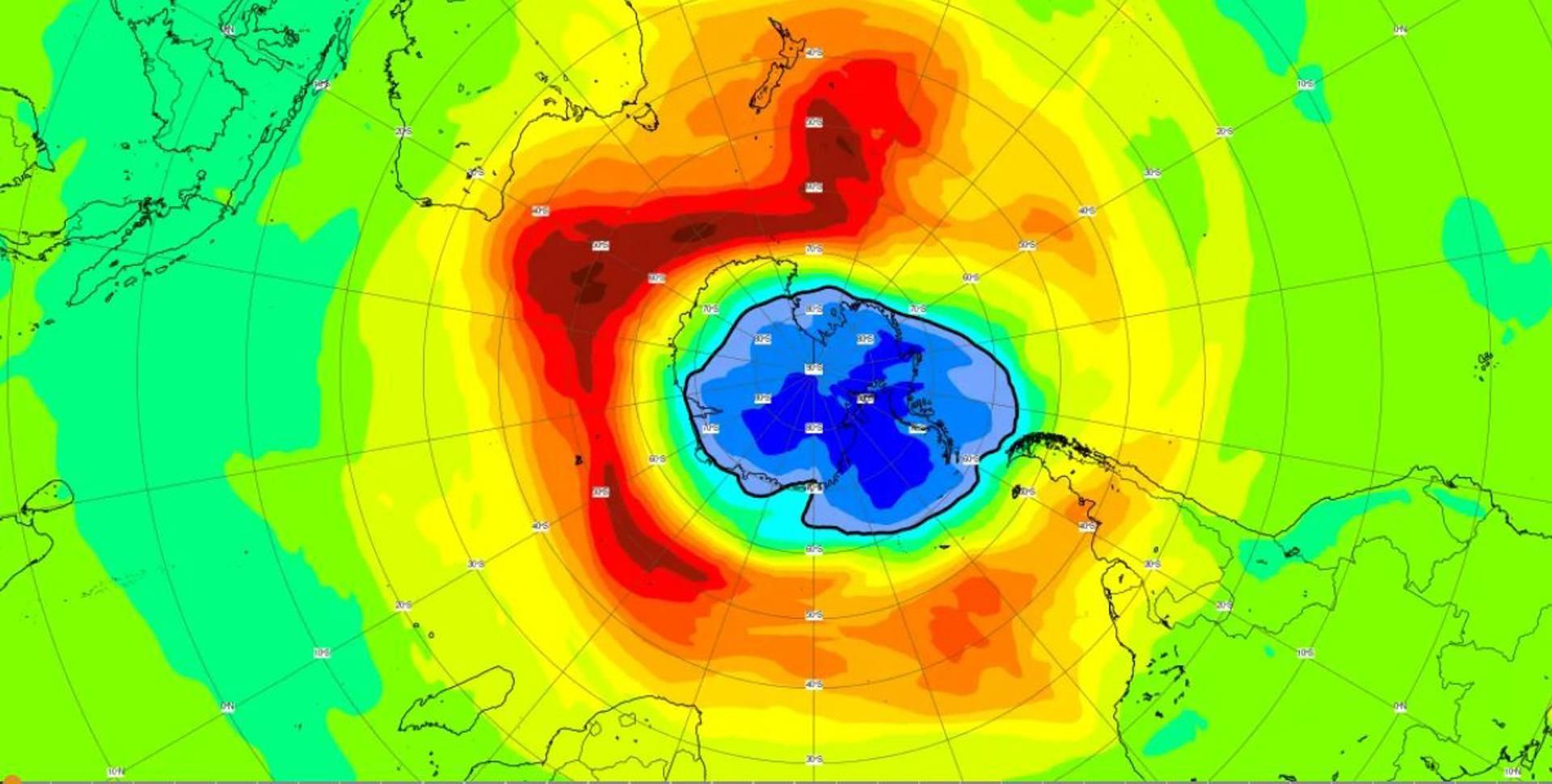 Gráfico con la extensión del agujero de ozono antártico este año en la región antártica proporcionado por el servicio de Monitoreo Atmosférico de Copernicus. Las áreas de color amarillo, naranja y rojo representan los valores altos de ozono, mientras que las áreas verdes y azules muestran los valores bajos. La línea negra continua se utiliza comúnmente para definir el área del agujero de ozono. 