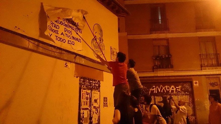 Pegada de un cartel, de noche, en una calle madrileña