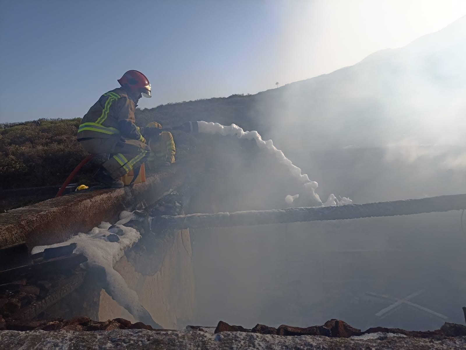 Miembros del dispositivo de extinción pagando el fuego en el pajero situado en el municipio de Villa de Mazo.