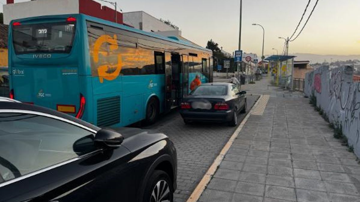 Dos coches aparcados en la parada frente a la calle La Tornera impiden que la guagua pueda dejar a los pasajeros en la acera.