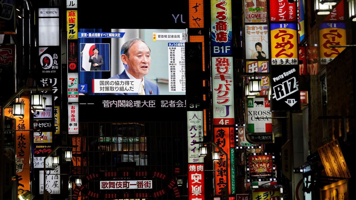 A large screen shows Japanese Prime Minister Yoshihide Suga announcing the end of the COVID-19 state of emergency during a televised news conference in Tokyo, Japan, 28 September 2021. Japanese Prime Minister Yoshihide Suga announced the government decided to lift the state of emergency in Tokyo and 18 prefectures following the decrease of number of new cases.
