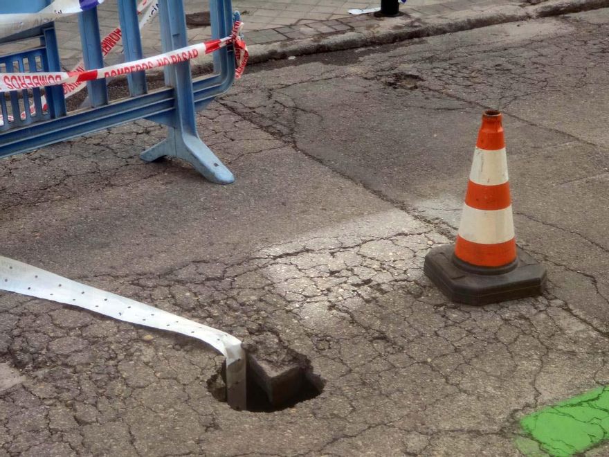 La valla y la cinta que señalizan el boquete son constantemente apartados y las motos de los repartidores siguen pasando