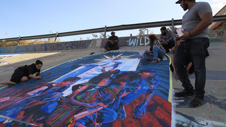Activistas pintan mural binacional en bordo de río que divide México y EE.UU.