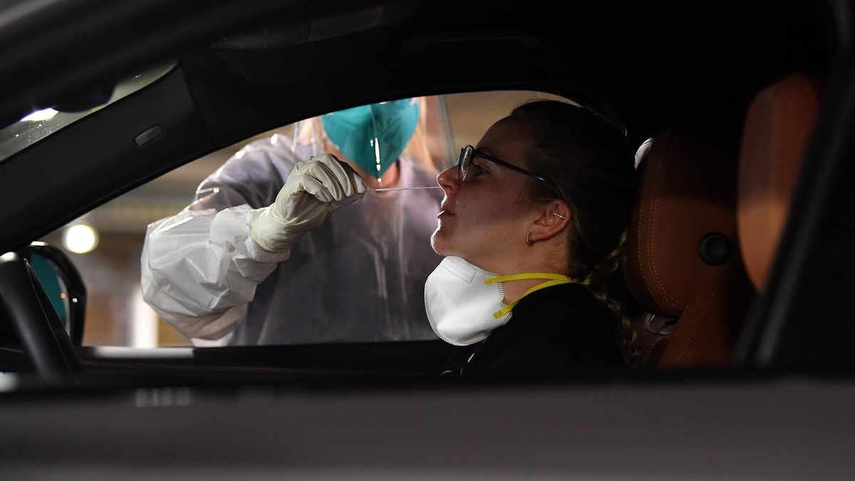 Registered Nurse Niamh Costello performs a Covid-19 Rapid Antigen Test at a drive-through testing facility set up by Blooms the Chemist at the Royal Randwick shopping centre car park in Sydney, Australia, 07 October 2021.