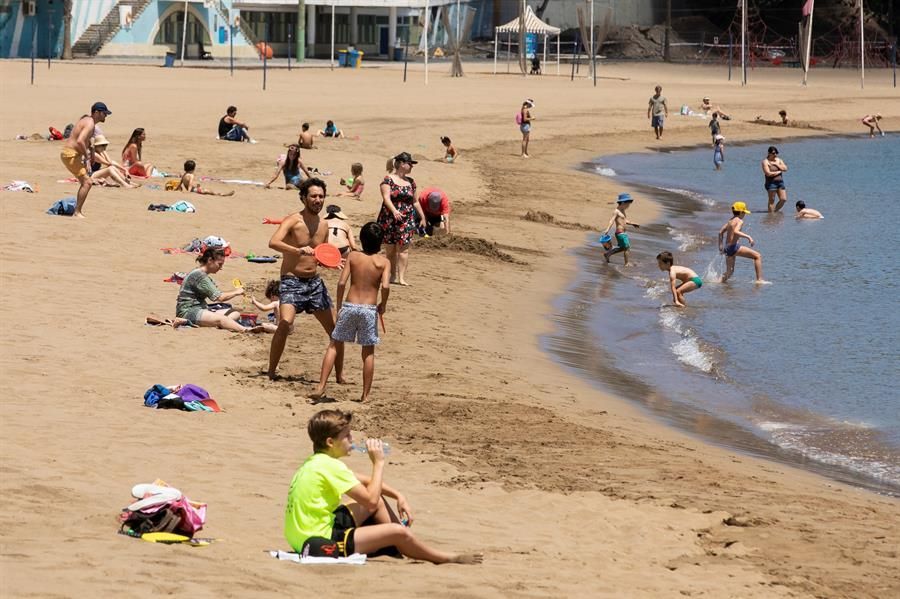 Varias personas en la playa de Las Alcaravaneras este domingo (Efe / Quique Curbelo)