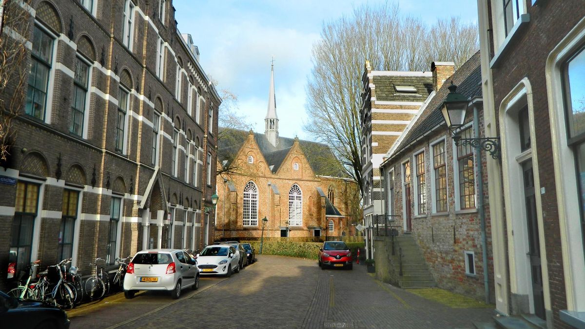 La Iglesia de Los Jacobinos emerge al final de una calle con viejas casas de ladrillo.