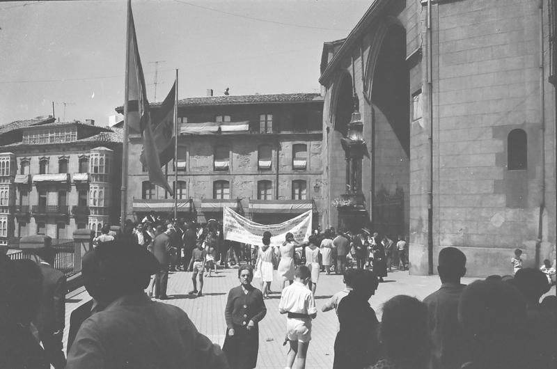 Ofrendas florales a la Virgen Blanca en 1964 bajo dos grandes banderas, la de la España franquista y la de Vitoria