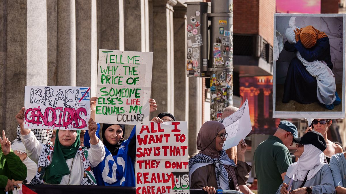 Varias personas con carteles propalestinos antes de pasar la etapa final de la Vuelta Ciclista a España, a 14 de septiembre de 2025, en Madrid