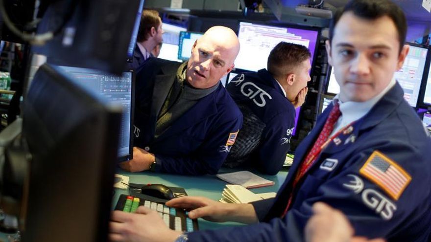 Traders work on the floor of the New York Stock Exchange at the start of the trading day in New York, New York, USA, 03 December 2019.