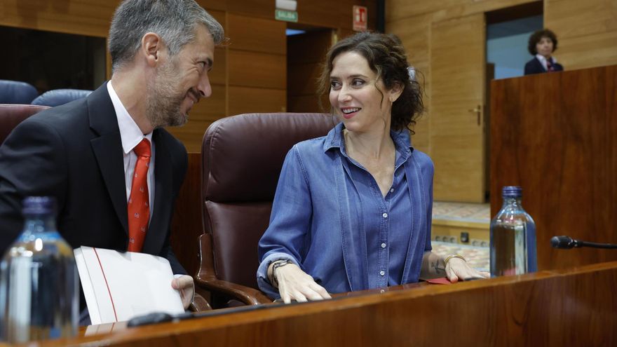La presidenta de la Comunidad de Madrid, Isabel Díaz Ayuso, conversa con su consejero de Presidencia, Justicia y Administración Local, Miguel Ángel García, a su llegada a la Asamblea de Madrid.