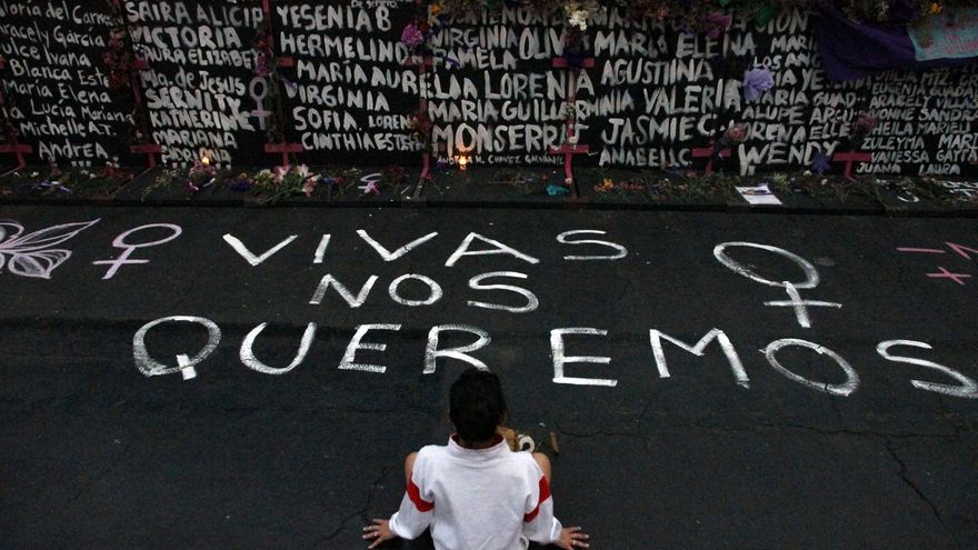 Una mujer participa durante una actuación de grupos feministas, para escribir nombres de víctimas de feminicidios y colocar flores en protesta contra la violencia de género, como parte de las protestas del Día Internacional de la Mujer en el Palacio Nacional el 7 de marzo de 2021 en la Ciudad de México, México