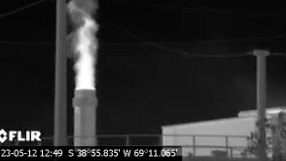 La foto digital de la chimenea detrás de un tanque dentro de la Refinería Plaza Huincul YPF no demuestra señales visibles de emisiones de gases o bruma de calor, en cuanto la captura de pantalla del video de OGI filmado al mismo tiempo registra lo que aparentan ser plumas de contaminación de hidrocarburos que incluyen metano y otros compuestos nocivos que resultan del proceso de combustión incompleta.