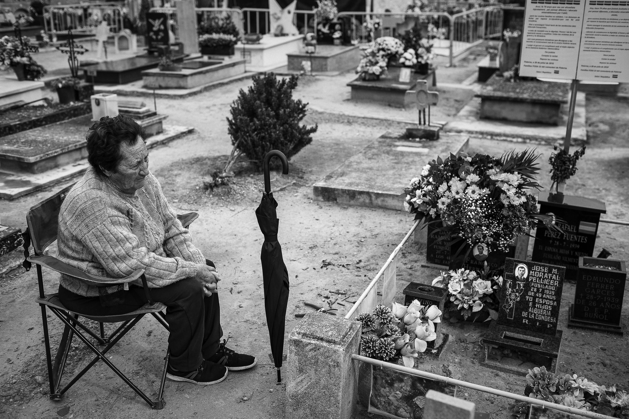 Dona asseguda a peu de la fossa 22 de Paterna.