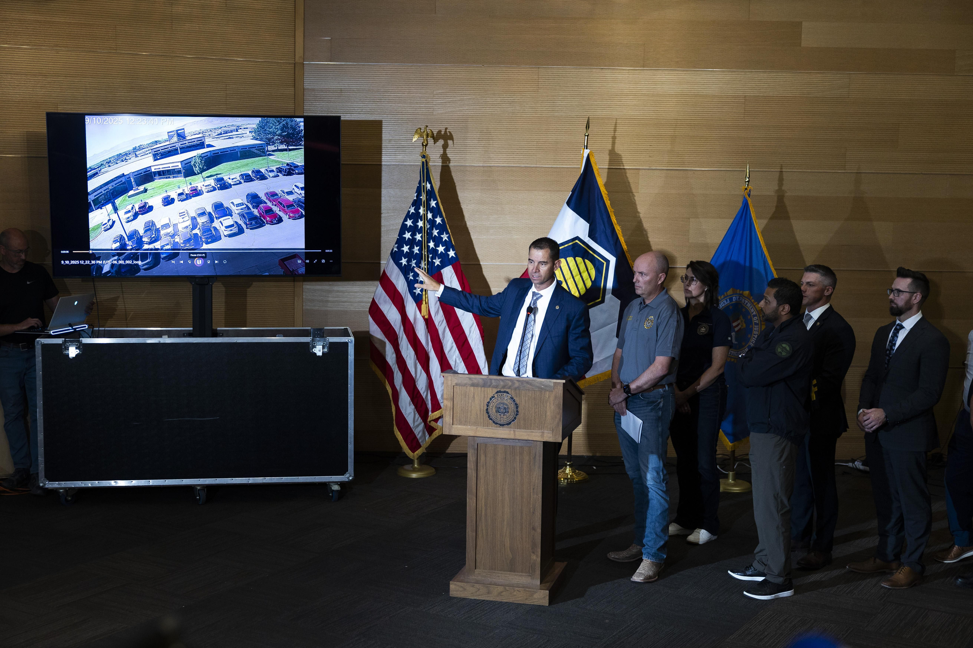 The Commissioner of the Department of Public Security of Utah, Beau Mason, shows a video of a suspect during a press conference with the governor of Utah, Spencer Cox, (second from the left), the vice governor of Utah, Deidre Henderson (center), and the director of the FBI, Kash Patel (second from the right), at the University of the Valley of Utah on September 11, OEM, Utah.