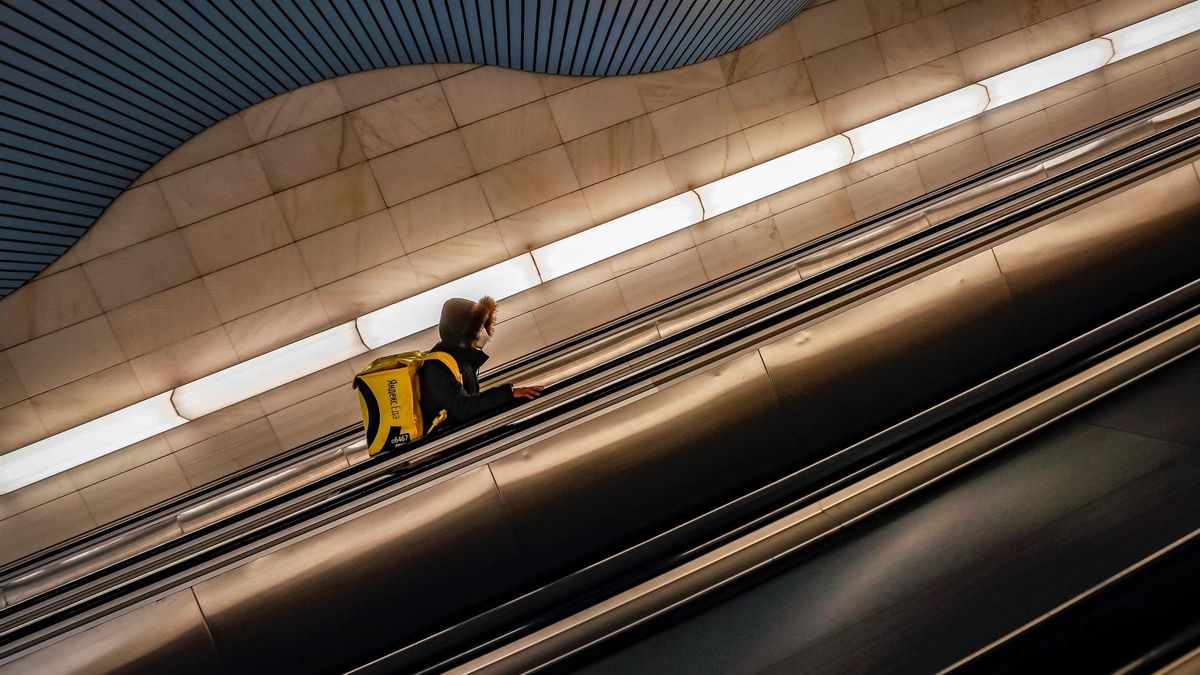 A food delivery man wearing a protective face mask goes up the escalator in a Metro station during the COVID-19 pandemic in Moscow, Russia, 02 February 2022. According to the national coronavirus information center, over the past 24 hours, a record number of 141,883 cases of the coronavirus infection have been detected in Russia.
