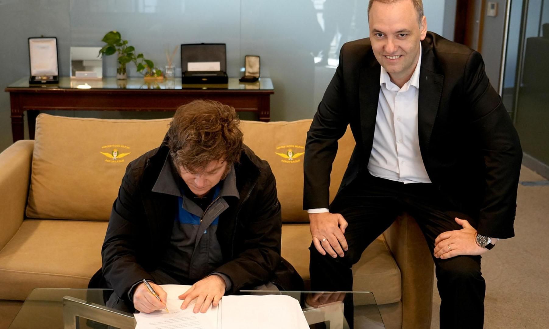 El presidente Javier Milei firmando el proyecto de reforma laboral junto a Manuel Adorni
