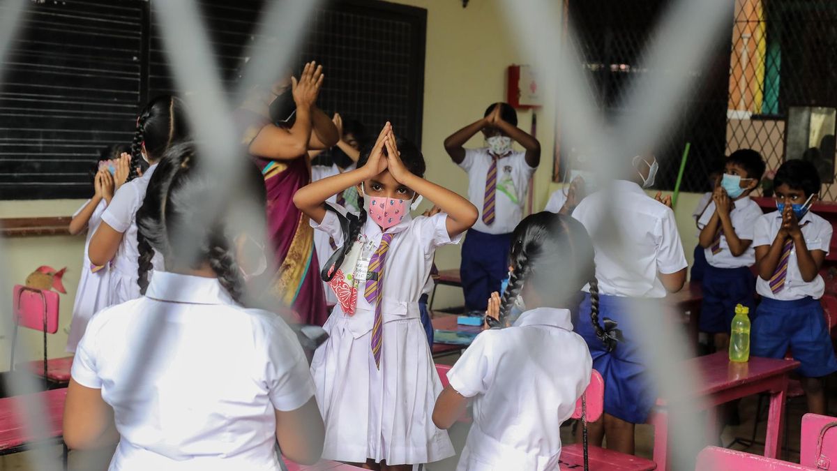 Sri Lankan primary section students attend morning religious observances before class on the first day of school after reopening, at Munidasa Kumaratunga School, in the suburbs of Colombo, Sri Lanka, 25 October 2021. The Sri Lankan government reopened the primary section schools on 25 October 2021, after nearly six months of lockdown as per the second phase of school reopening.