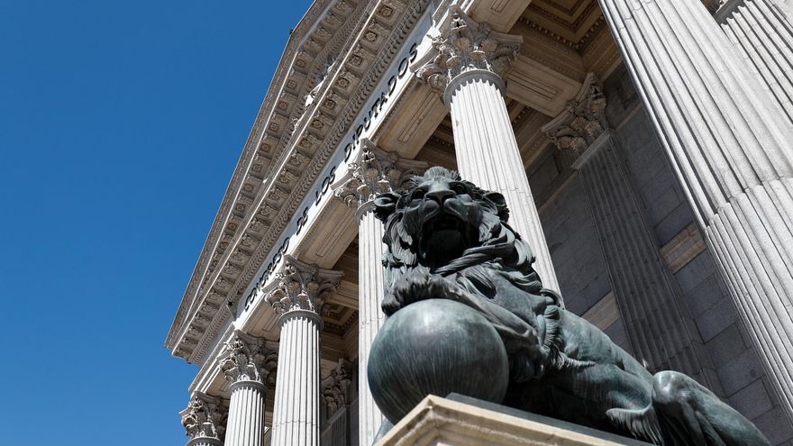 Archivo - Uno de los emblemáticos leones que se encuentran delante de la fachada del Congreso de los Diputados en la Plaza de las Cortes de Madrid.