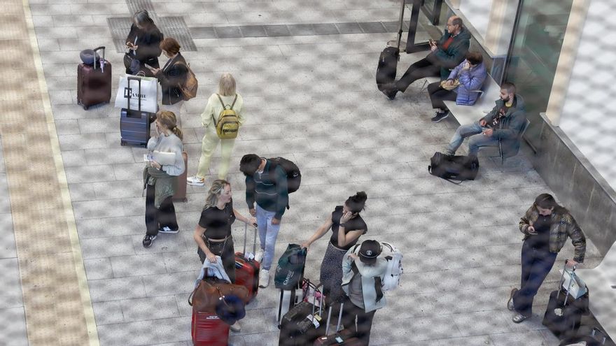 Un grupo de pasajeros espera este martes en la estación de Renfe de San Sebastián la reactivación del servicio.