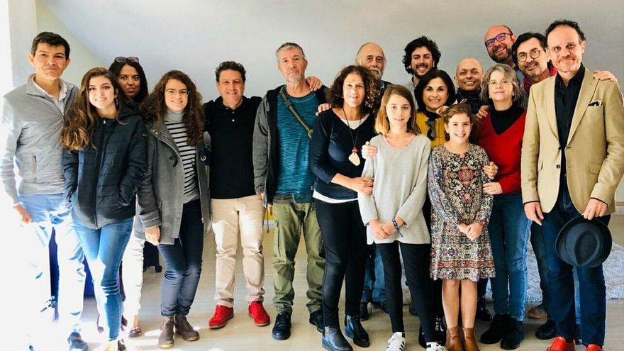 Diego Ramos, con polo negro, a la izquierda, con sus amigos congregados en su estudio