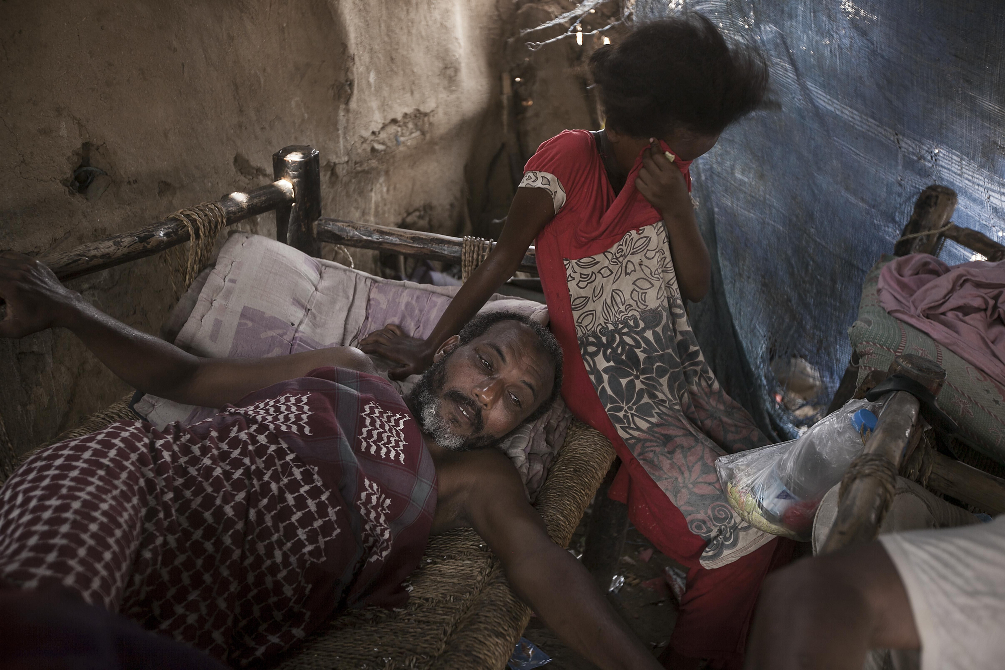 Muchos de los desplazados han podido alojarse en casas de familiares y amigos. Otros han encontrado cobijo en edificios abandonados que no reúnen la infraestructura básica como letrinas y sistemas de alcantarillado para su uso. Miles, los más vulnerables, se han refugiado en campos improvisados donde se reúnen cientos de familias. Un familia en el interior de su tienda en el asentamiento temporal de Al Manjoorah. Fotografía: Narciso Contreras/MSF