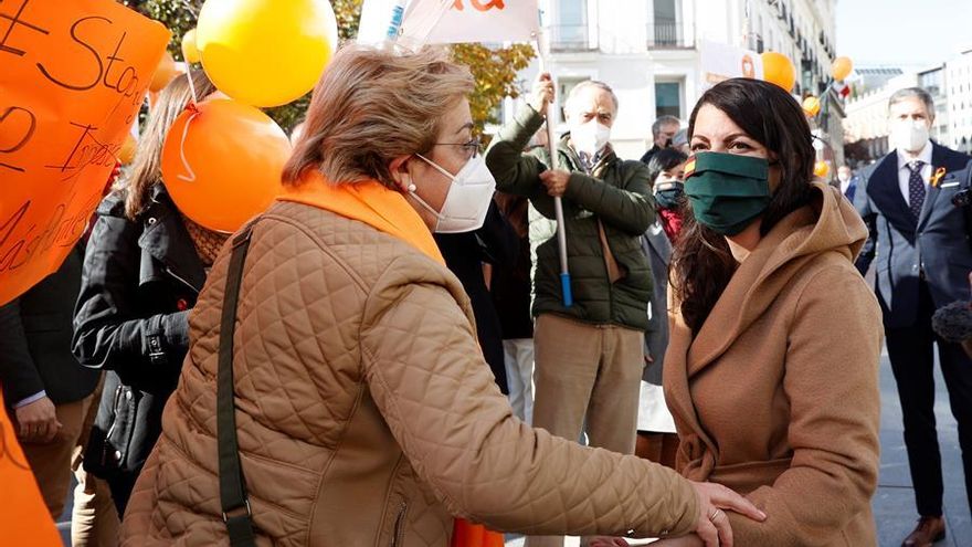 La diputada de Vox en el Congreso, Macarena Olona, saluda a los integrantes de la Plataforma Más Plurales este viernes frente al Congreso.