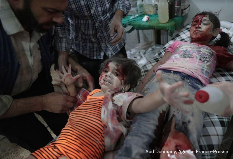Medics Assist a Wounded Girl / Abd Doumany, Syria, Agence France-Presse