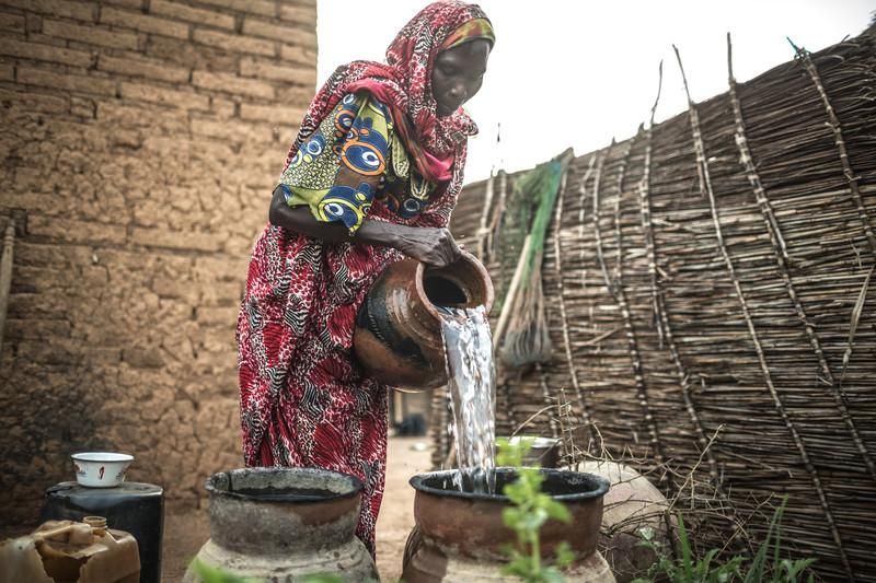 Akkoe Moussa, echando agua potable en un cántaro de cerámica / FOTO: Pablo Tosco - Oxfam Intermón