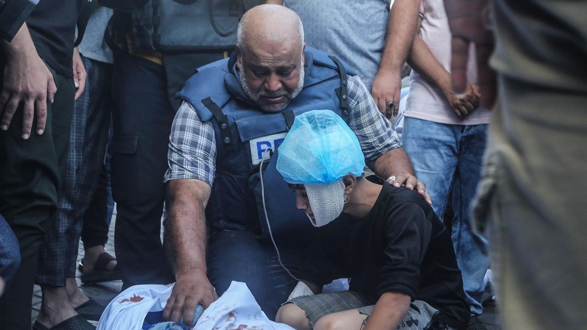 El corresponsal de Al Jazeera en palestina Wael Al Dahdouh, junto al cuerpo de uno de sus familiares asesinados en un ataque israelí.