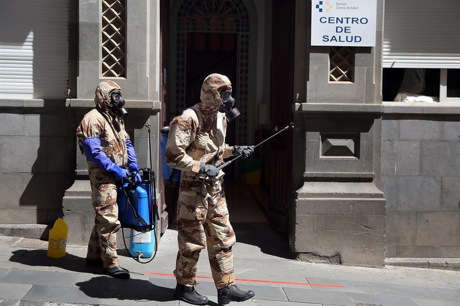Efectivos del Ejército de Tierra, con trajes de protección, realizan labores de desinfección en el centro de salud de la zona centro de Santa Cruz