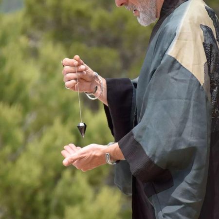 Marcos Benavent, el autodenominado 'yonki del dinero', sostiene un péndulo.