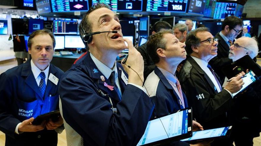 Traders work on the floor of the New York Stock Exchange in New York, New York, USA, on 04 March 2020.