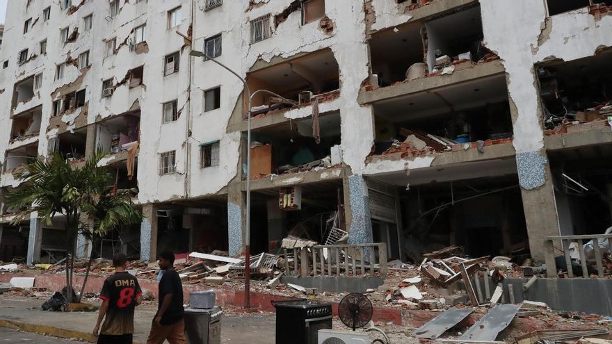 Personas caminan este sábado frente a edificios afectados por los terremotos ocurridos en la zona de Caraballeda, en La Guaira (Venezuela). EFE/ Raúl Martínez