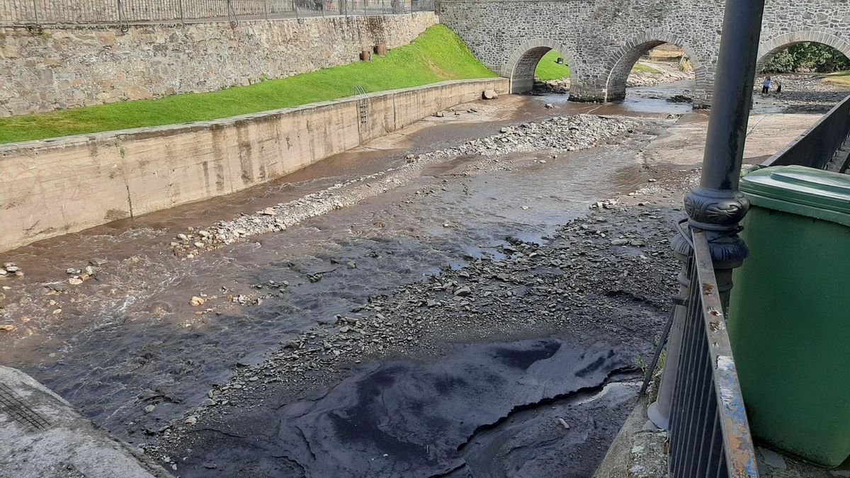 La playa fluvial de Molinaseca llena de lodo por las tormentas y los arrastres de los incendios forestales.